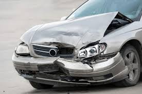 A car with the front end and hood of their car scrunched after an auto accident, needing car repairs.