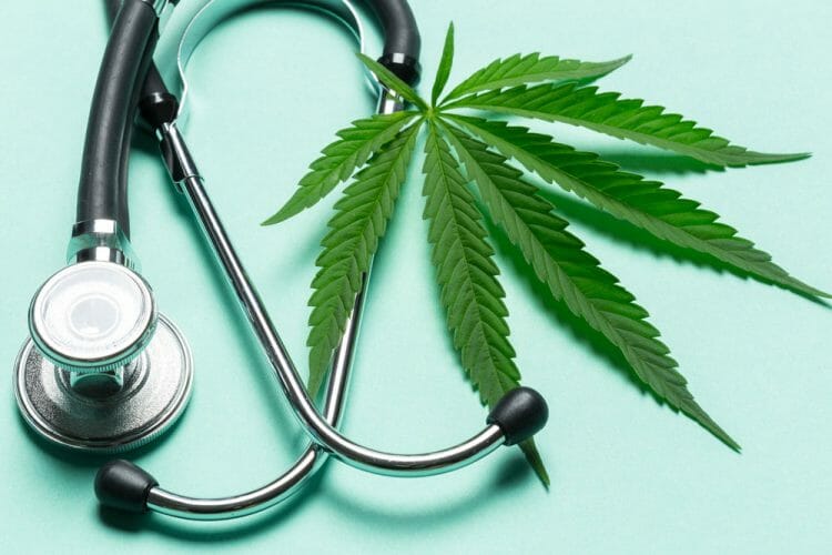 A stethoscope and a medical marijuana leaf to represent how medical marijuana can affect workers' compensation claims.