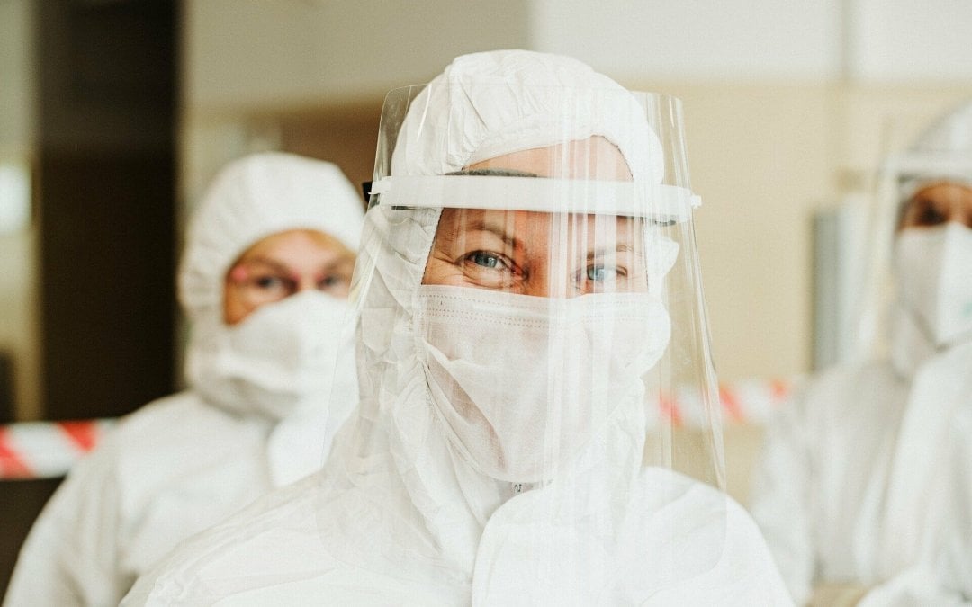 Several healthcare workers with their face shields, masks and other PPE during the COVID-19 outbreak.